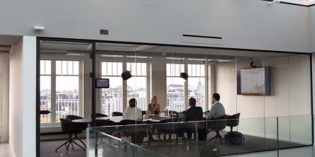 A team in an office discussing relationship mapping during a meeting