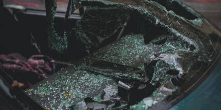 The smashed front windows of a car after an accident.